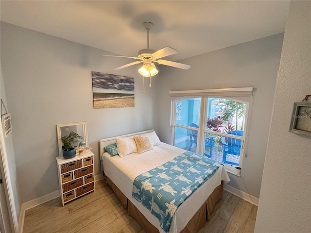 bedroom with ceiling fan and light hardwood / wood-style flooring