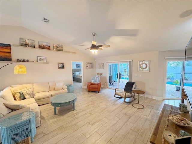 living room featuring vaulted ceiling, plenty of natural light, and light wood-type flooring