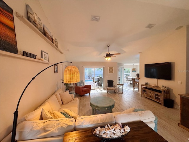 living room with ceiling fan and light hardwood / wood-style flooring