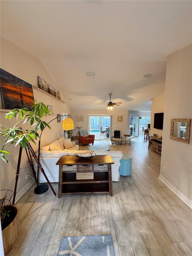 living room with hardwood / wood-style flooring, vaulted ceiling, ceiling fan, and plenty of natural light