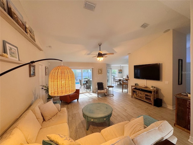 living room featuring ceiling fan, lofted ceiling, and hardwood / wood-style floors