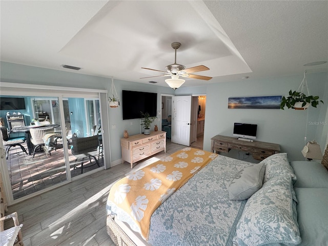 bedroom featuring hardwood / wood-style floors, access to outside, and ceiling fan