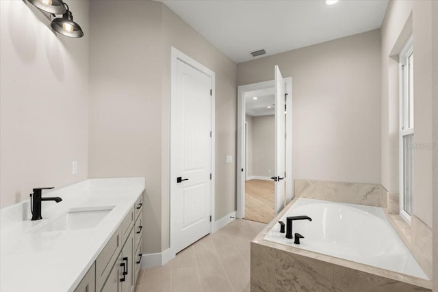 full bath featuring baseboards, visible vents, a garden tub, tile patterned flooring, and vanity