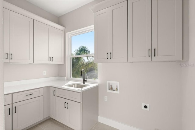 clothes washing area with washer hookup, light tile patterned floors, cabinet space, hookup for an electric dryer, and a sink