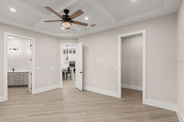 unfurnished bedroom with baseboards, visible vents, and light wood finished floors