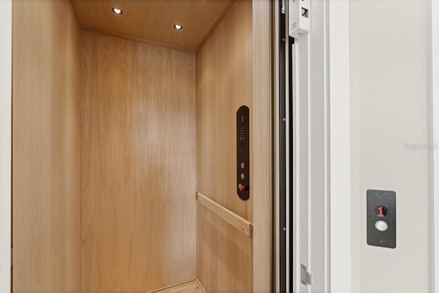 room details featuring elevator, wood ceiling, and recessed lighting