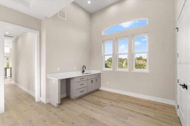 interior space with recessed lighting, wood finished floors, vanity, visible vents, and baseboards