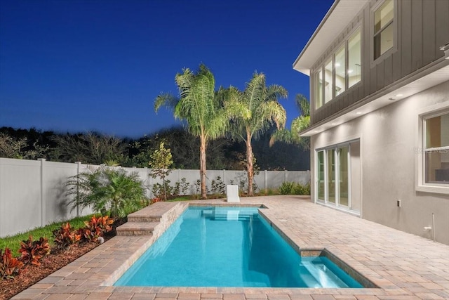 view of swimming pool with a fenced backyard, a fenced in pool, and a patio