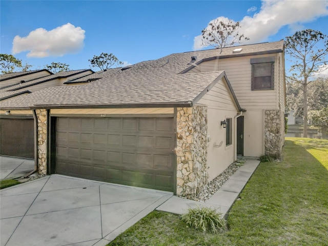 view of side of home featuring a yard and a garage