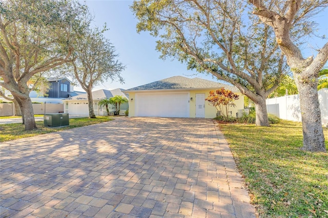 single story home featuring a garage and a front lawn