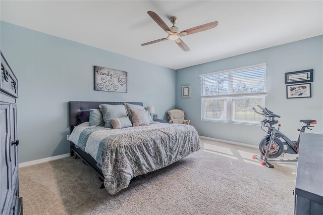 carpeted bedroom with baseboards and a ceiling fan