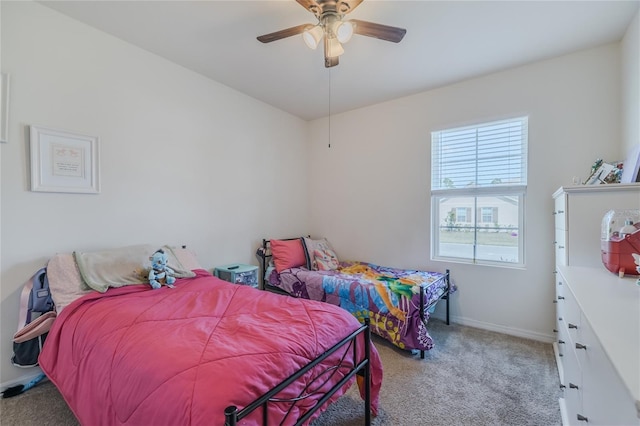 bedroom with baseboards, a ceiling fan, and light colored carpet