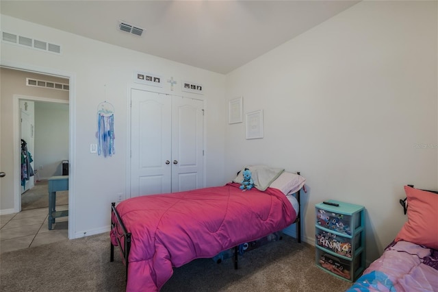 bedroom featuring a closet, carpet, and visible vents