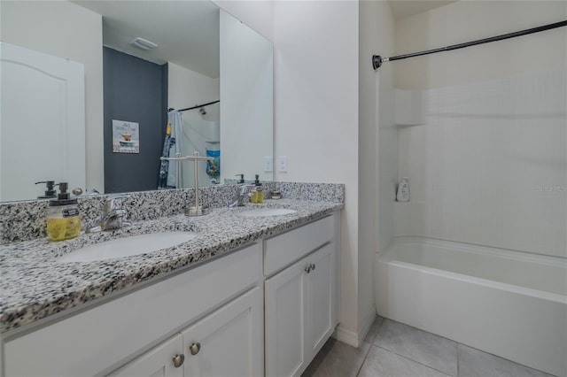 full bath featuring double vanity, shower / bath combination, a sink, and tile patterned floors