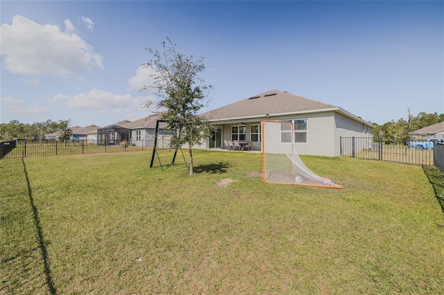 back of property featuring a fenced backyard, a lawn, and stucco siding