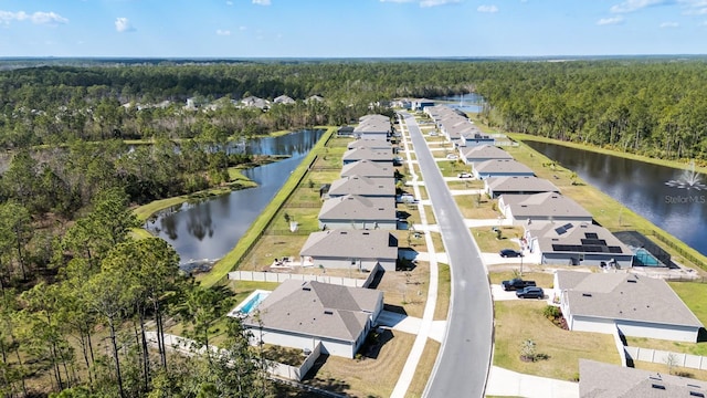 aerial view featuring a forest view, a water view, and a residential view