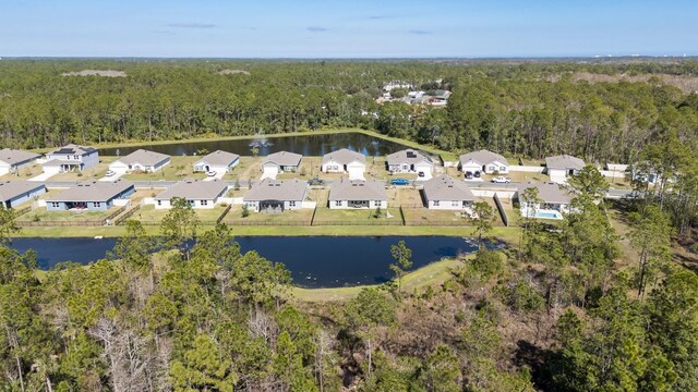 bird's eye view with a water view and a wooded view