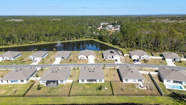 birds eye view of property featuring a water view, a residential view, and a wooded view