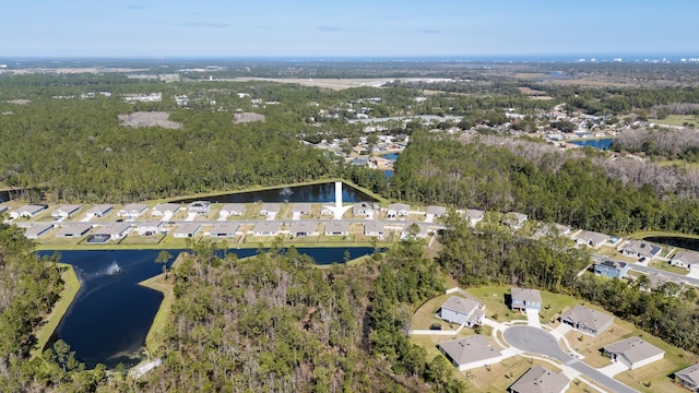 birds eye view of property featuring a water view, a forest view, and a residential view