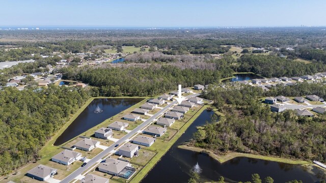 bird's eye view featuring a water view, a residential view, and a wooded view