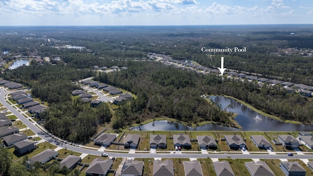 birds eye view of property featuring a residential view, a water view, and a forest view