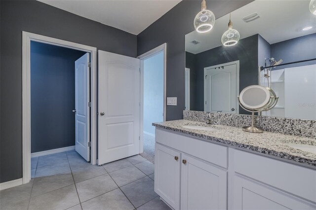 bathroom featuring double vanity, tile patterned flooring, a sink, and visible vents