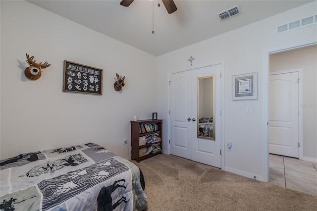 bedroom featuring visible vents, ceiling fan, light carpet, and baseboards