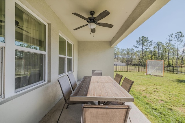 view of patio with outdoor dining area, a fenced backyard, and a ceiling fan