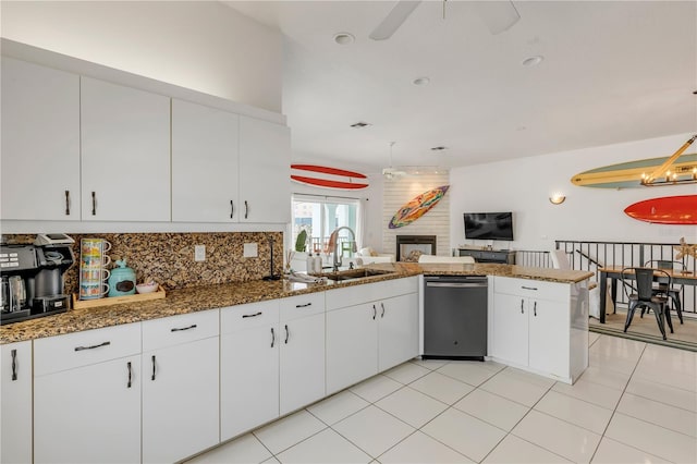 kitchen featuring sink, dishwasher, ceiling fan, white cabinets, and kitchen peninsula