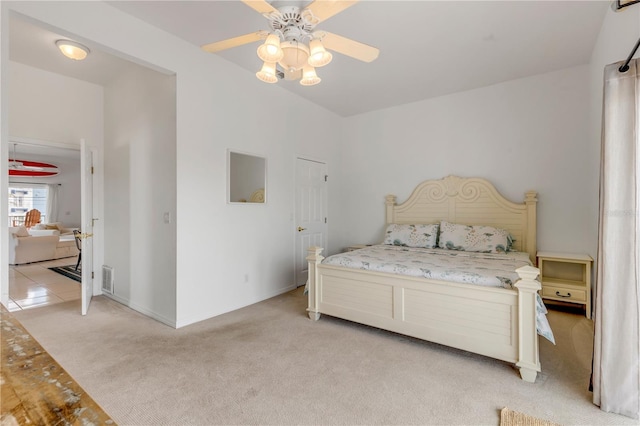 bedroom with light colored carpet and ceiling fan