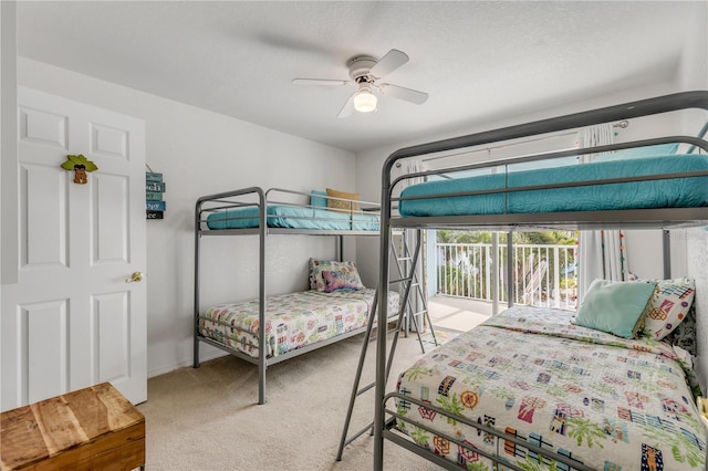 bedroom featuring light carpet, a textured ceiling, and ceiling fan