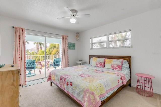 carpeted bedroom featuring multiple windows, a textured ceiling, access to outside, and ceiling fan