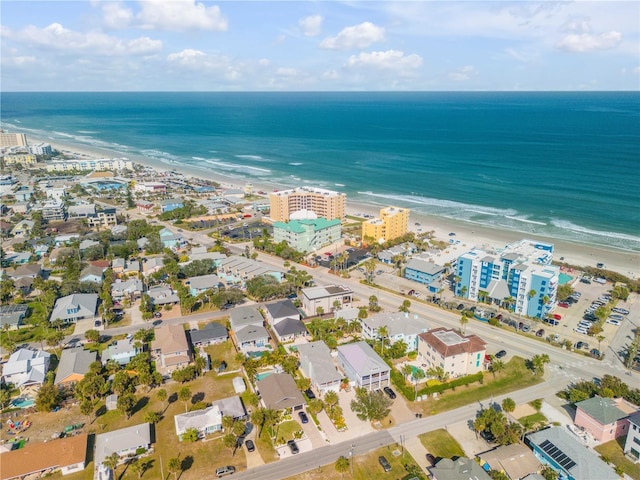 bird's eye view featuring a water view and a beach view