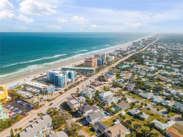 bird's eye view featuring a water view and a beach view
