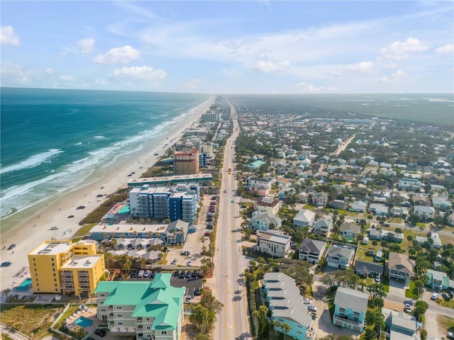 bird's eye view featuring a view of the beach and a water view