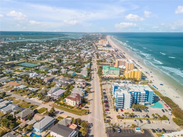 drone / aerial view featuring a water view and a beach view