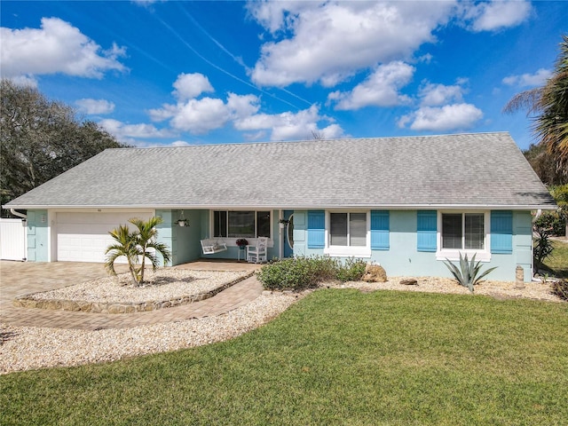 ranch-style home with a garage and a front yard