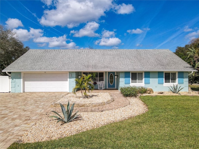 ranch-style home with a garage and a front yard