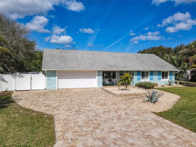 ranch-style house featuring a front lawn and a garage