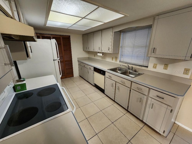 kitchen featuring sink, white appliances, and light tile patterned floors