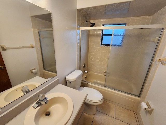 full bathroom featuring enclosed tub / shower combo, tile patterned floors, toilet, and vanity