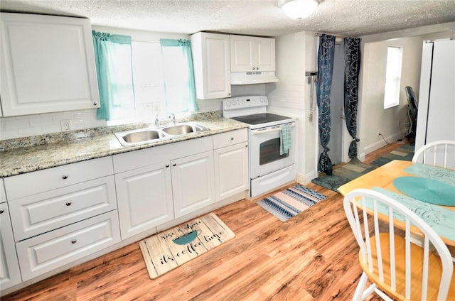 kitchen with white cabinets, a sink, white electric range oven, and under cabinet range hood