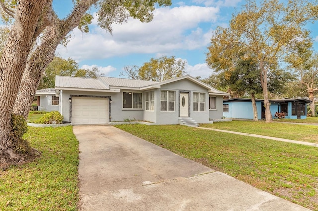 single story home featuring a garage and a front lawn