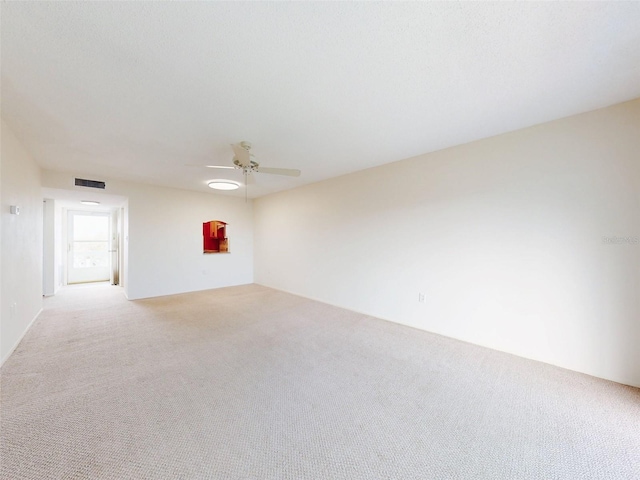 unfurnished room featuring ceiling fan, visible vents, and light colored carpet