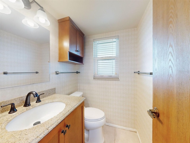 bathroom with toilet, tile patterned flooring, and vanity