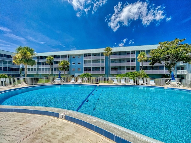 view of swimming pool with fence