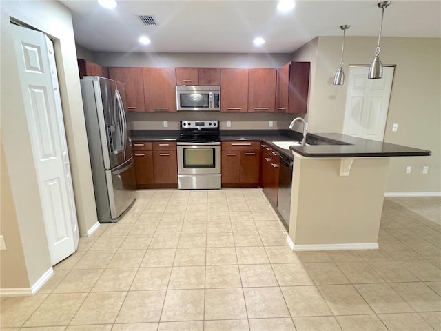 kitchen with dark countertops, visible vents, a peninsula, and appliances with stainless steel finishes