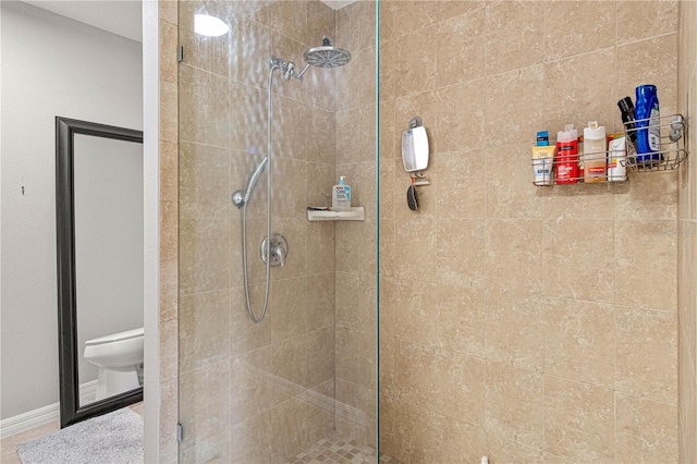 full bathroom featuring a stall shower and toilet