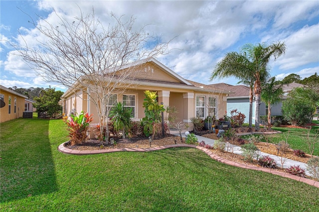 ranch-style house featuring a front yard and stucco siding