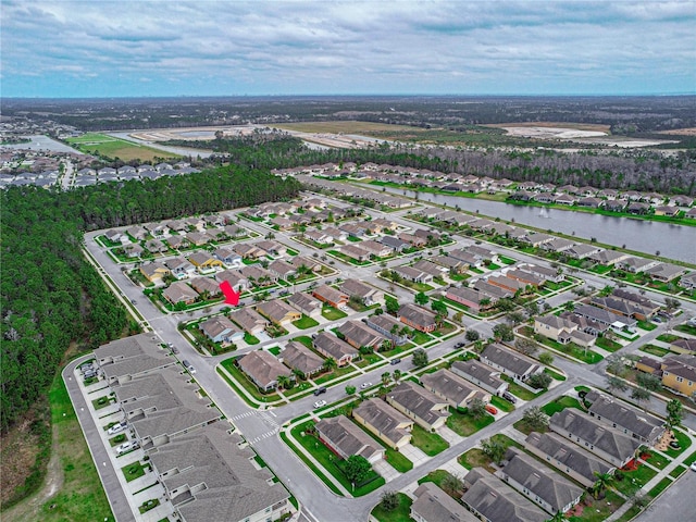 bird's eye view featuring a water view and a residential view